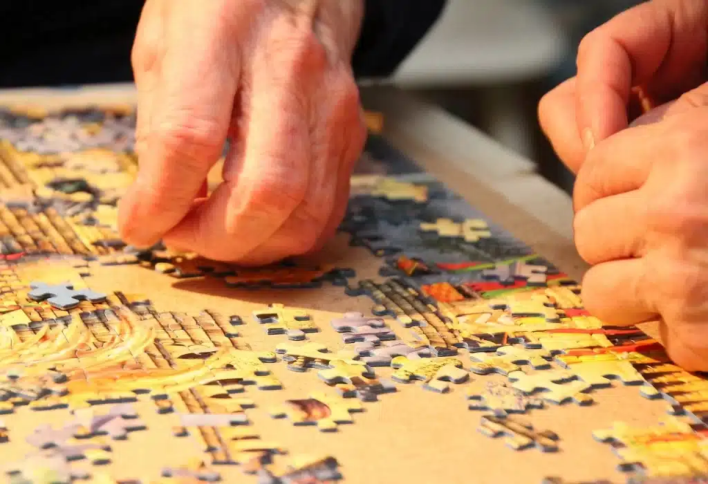 older puzzlers work a jigsaw together